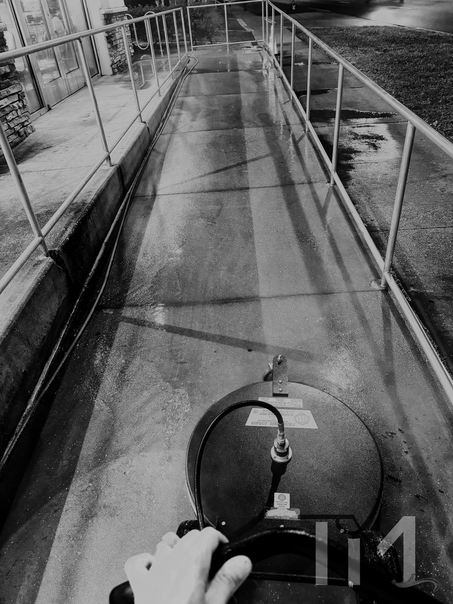 Surface cleaner cutting a clean path through a dirty concrete walkway in Lake County FL