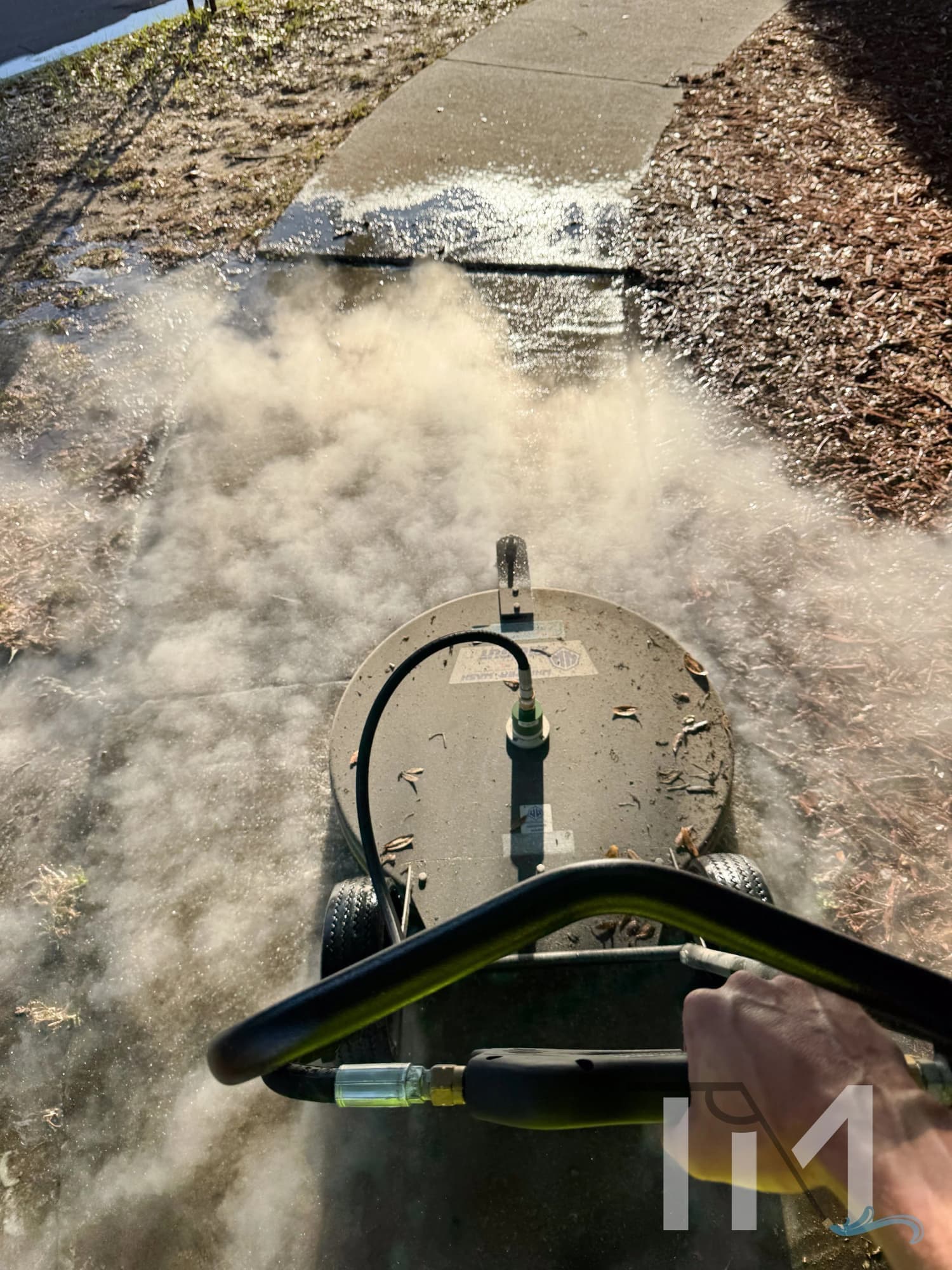 Hot water pass throwing steam off a sidewalk